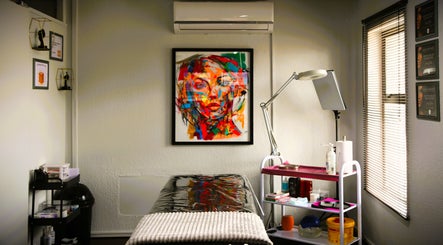 Inviting treatment room at OCD Permanent MakeUp, Krugersdorp, Gauteng, ZA, featuring vibrant wall art.