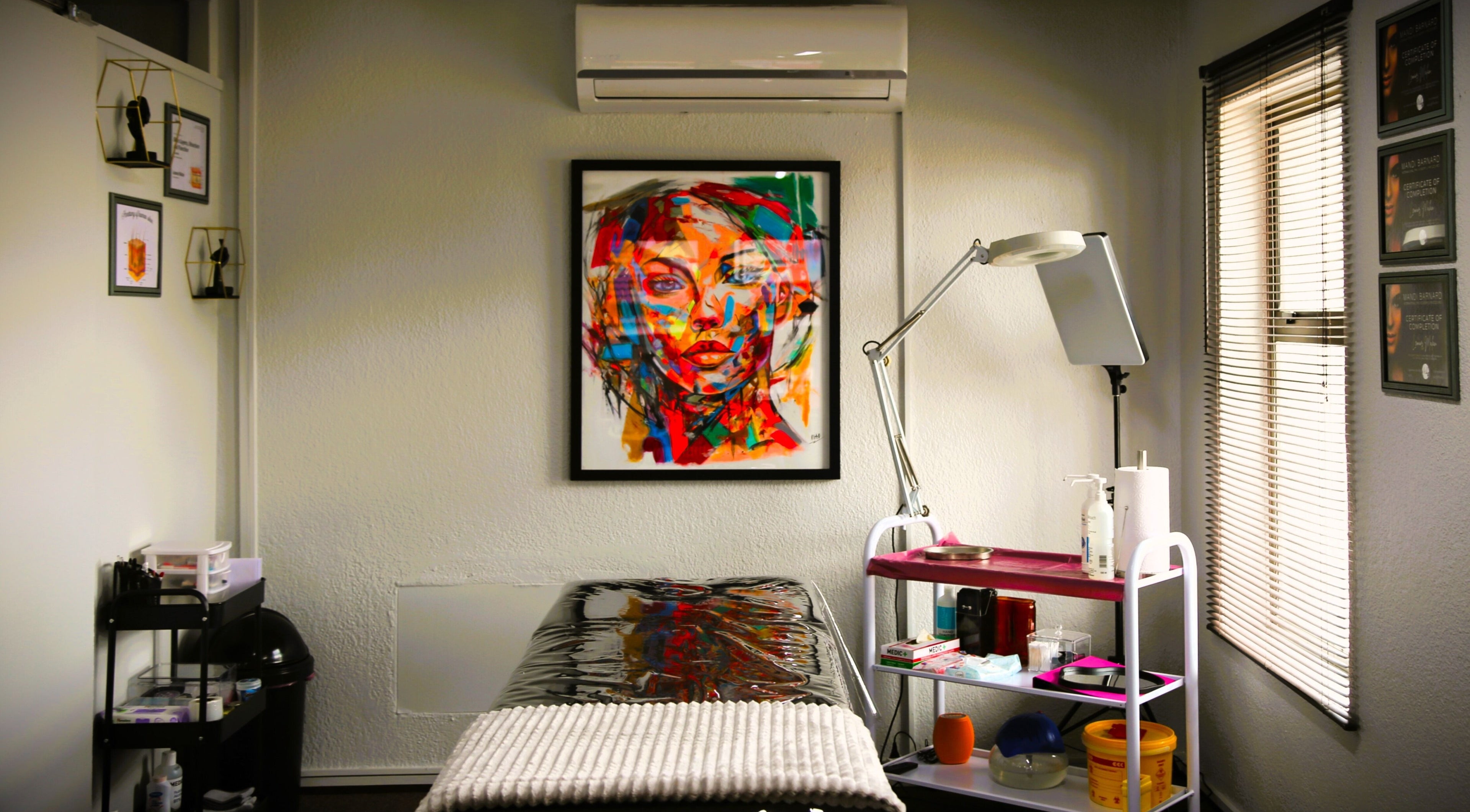 Inviting treatment room at OCD Permanent MakeUp, Krugersdorp, Gauteng, ZA, featuring vibrant wall art.