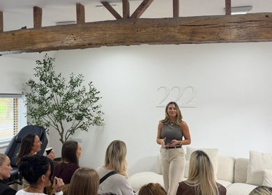 The Brow Secret, Stoke Gifford, England venue with a woman presenting to a seated group under wooden beams.