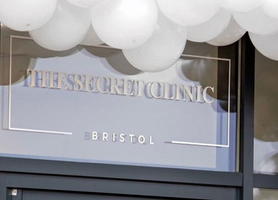 The Brow Secret entrance with balloons in Stoke Gifford, England, GB. Stylish and inviting salon facade.