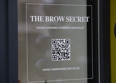 Entrance signage with QR code at The Brow Secret, Stoke Gifford, England, GB.