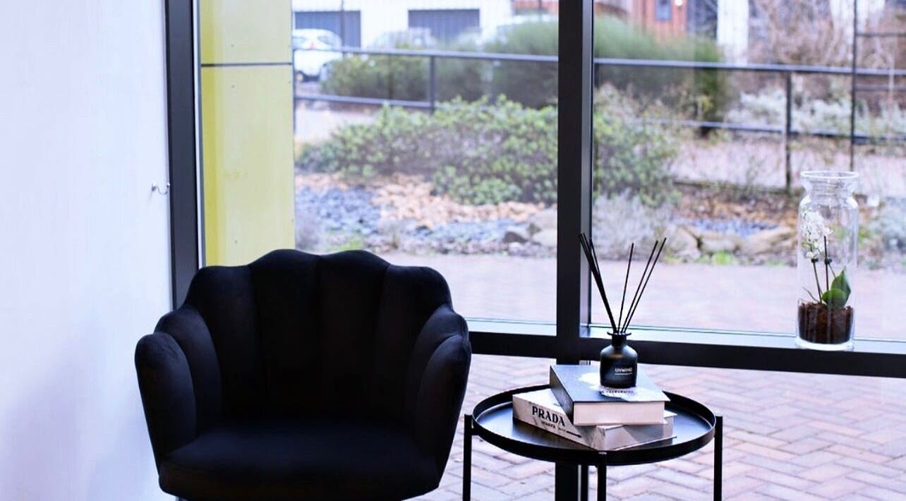 Elegant waiting area at The Brow Secret, Stoke Gifford, England, GB with a comfy chair and stylish decor.