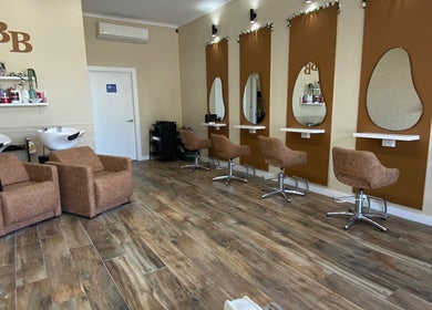 Modern salon interior at Hairbyloisbodie, Randwick, New South Wales, AU with stylish chairs and wash stations.
