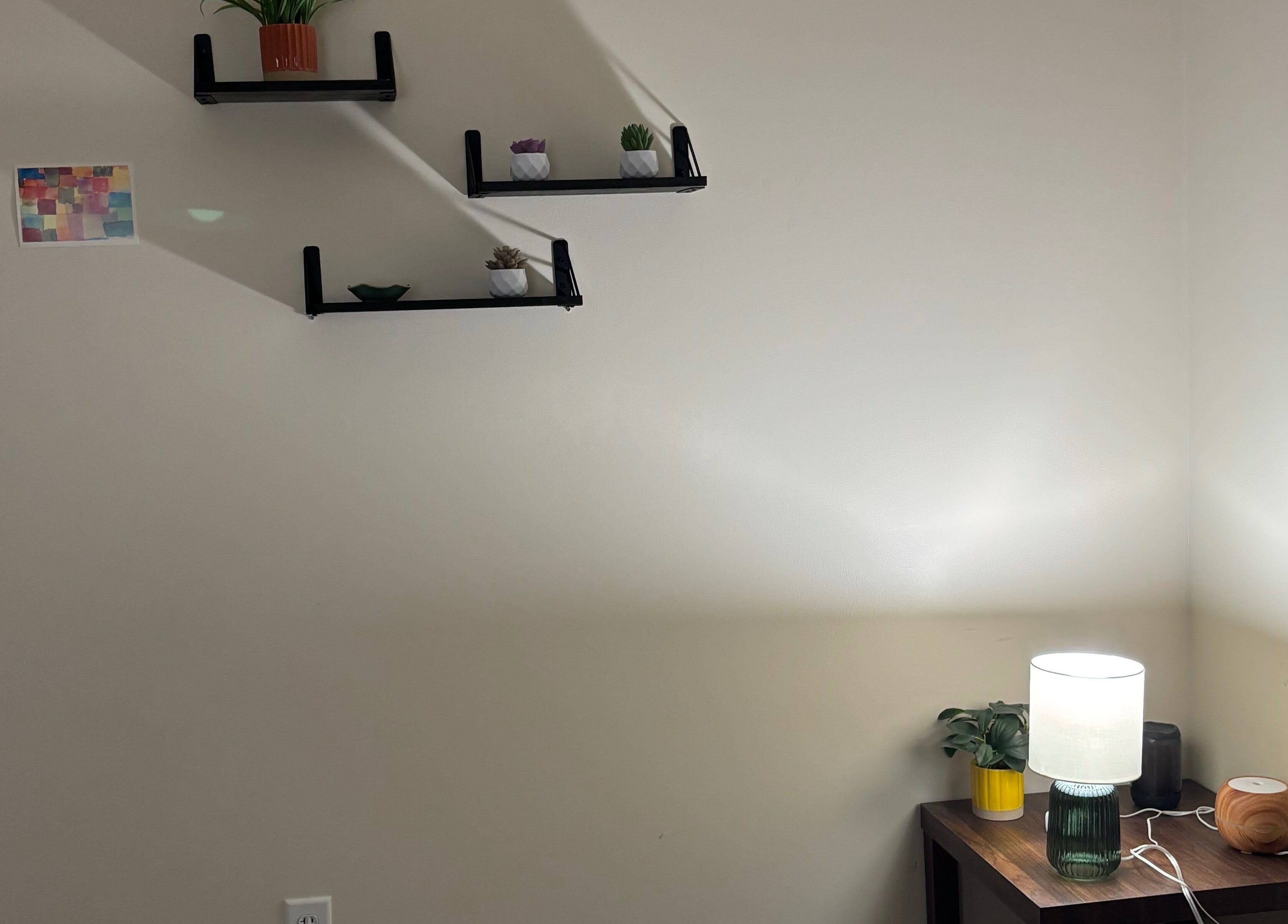Calming corner at Mindful Movements with Meghan, Marion, Ohio, US, featuring shelves and a softly lit lamp.