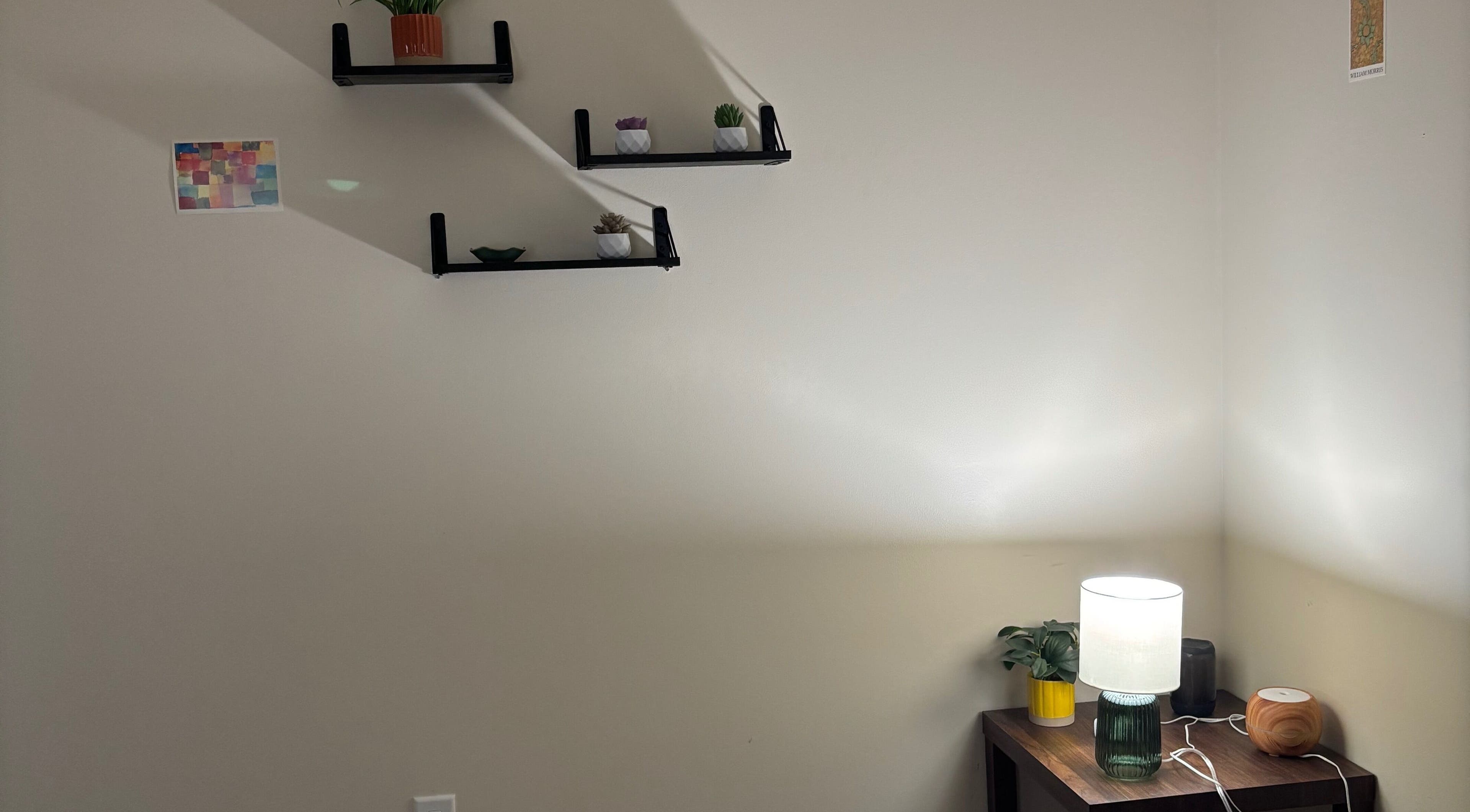 Calming corner at Mindful Movements with Meghan, Marion, Ohio, US, featuring shelves and a softly lit lamp.
