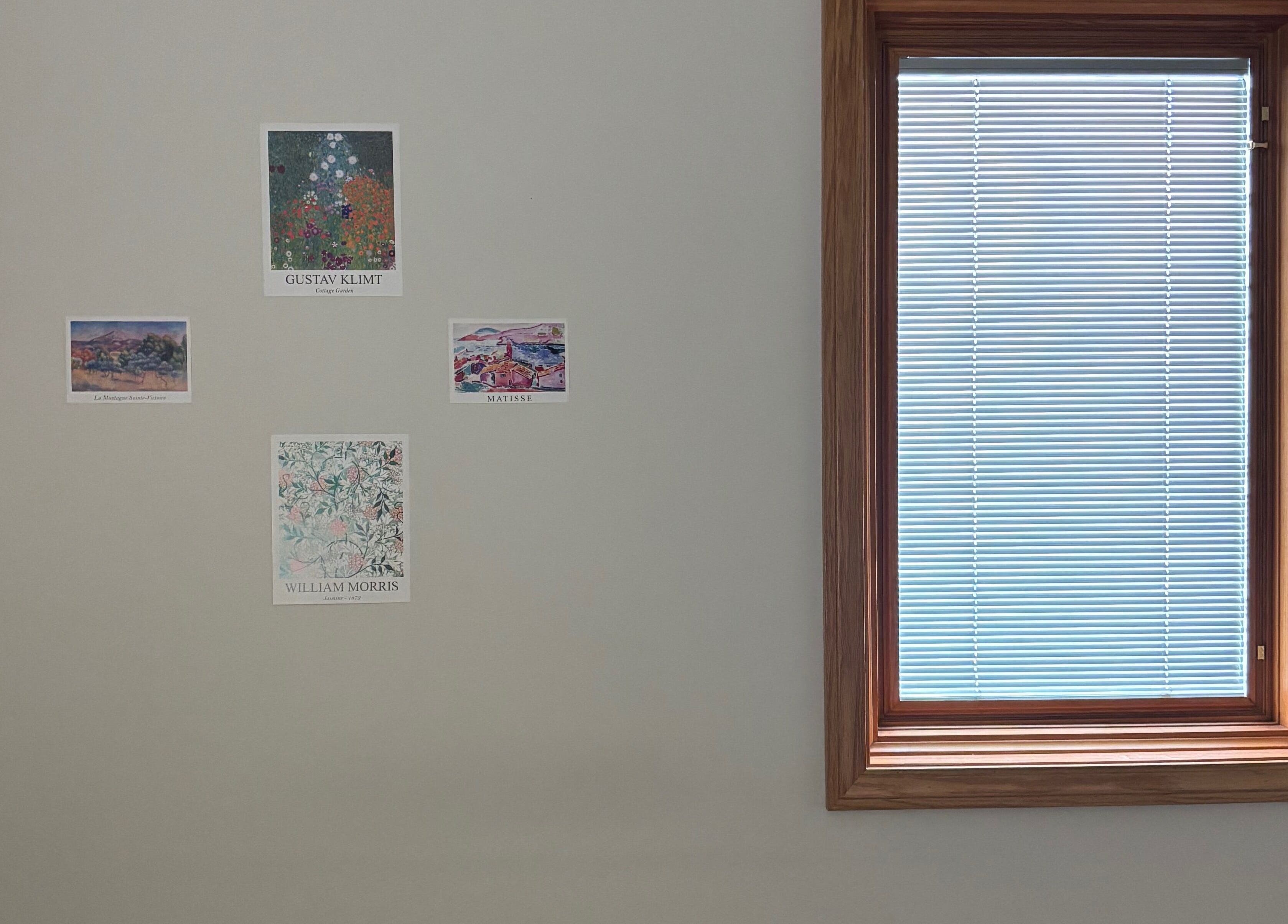 Art posters on a wall beside a window at Mindful Movements with Meghan in Marion, Ohio, US.