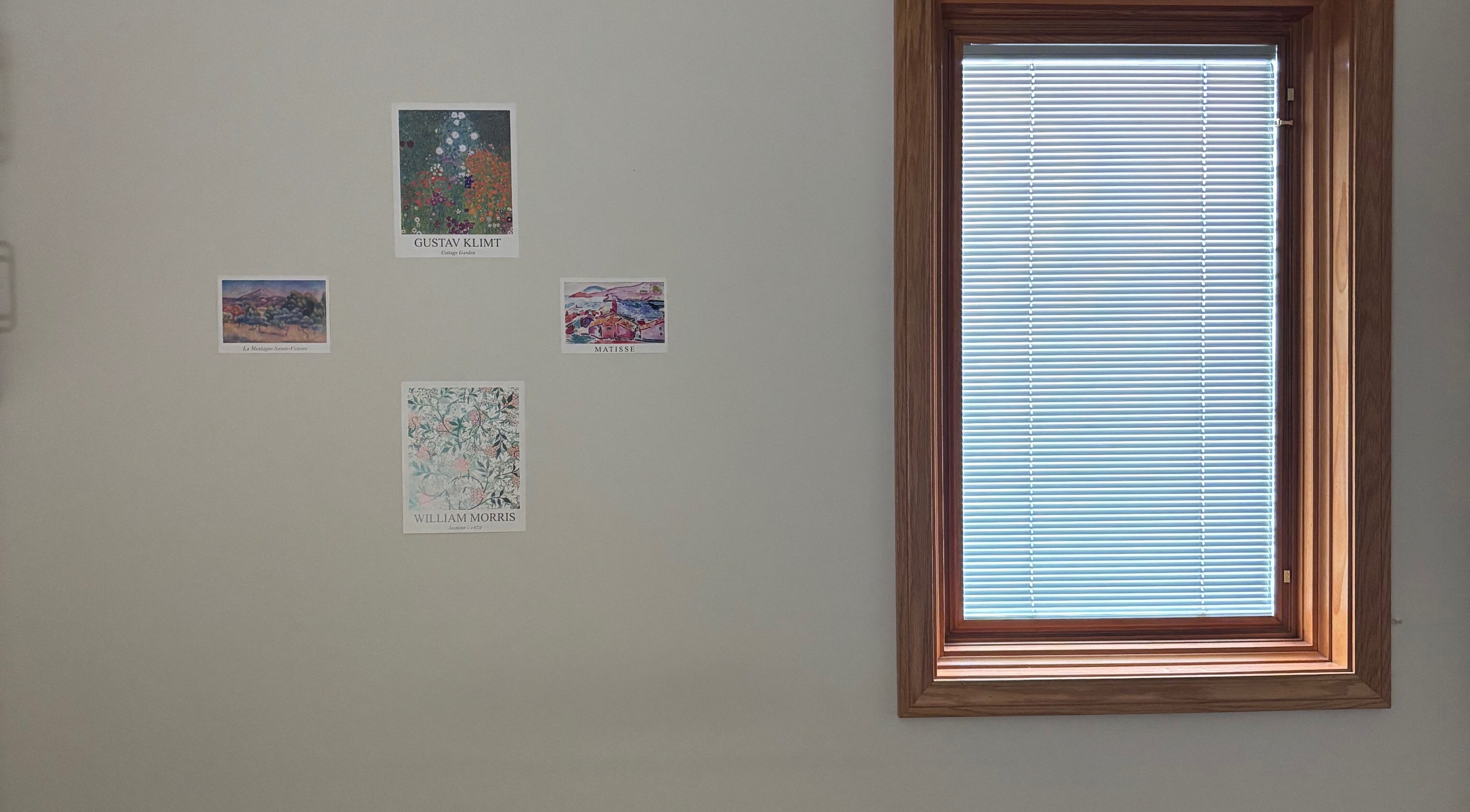 Art posters on a wall beside a window at Mindful Movements with Meghan in Marion, Ohio, US.