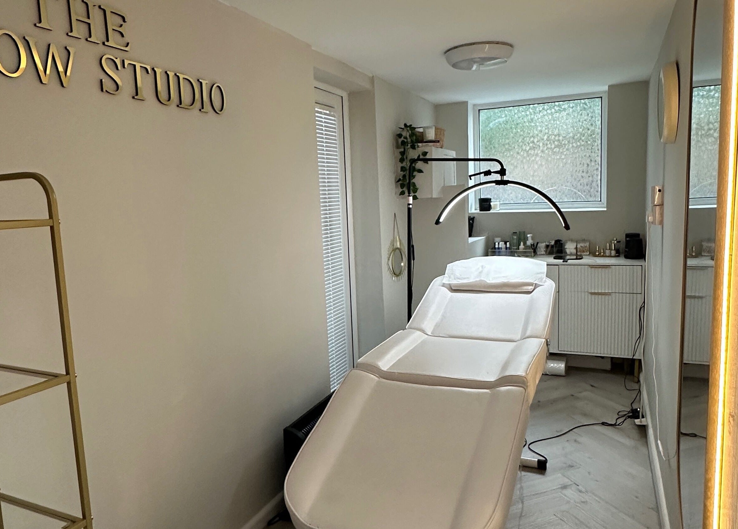 Relaxing interior of The Brow Studio in Wythenshawe, England featuring treatment bed and elegant decor.