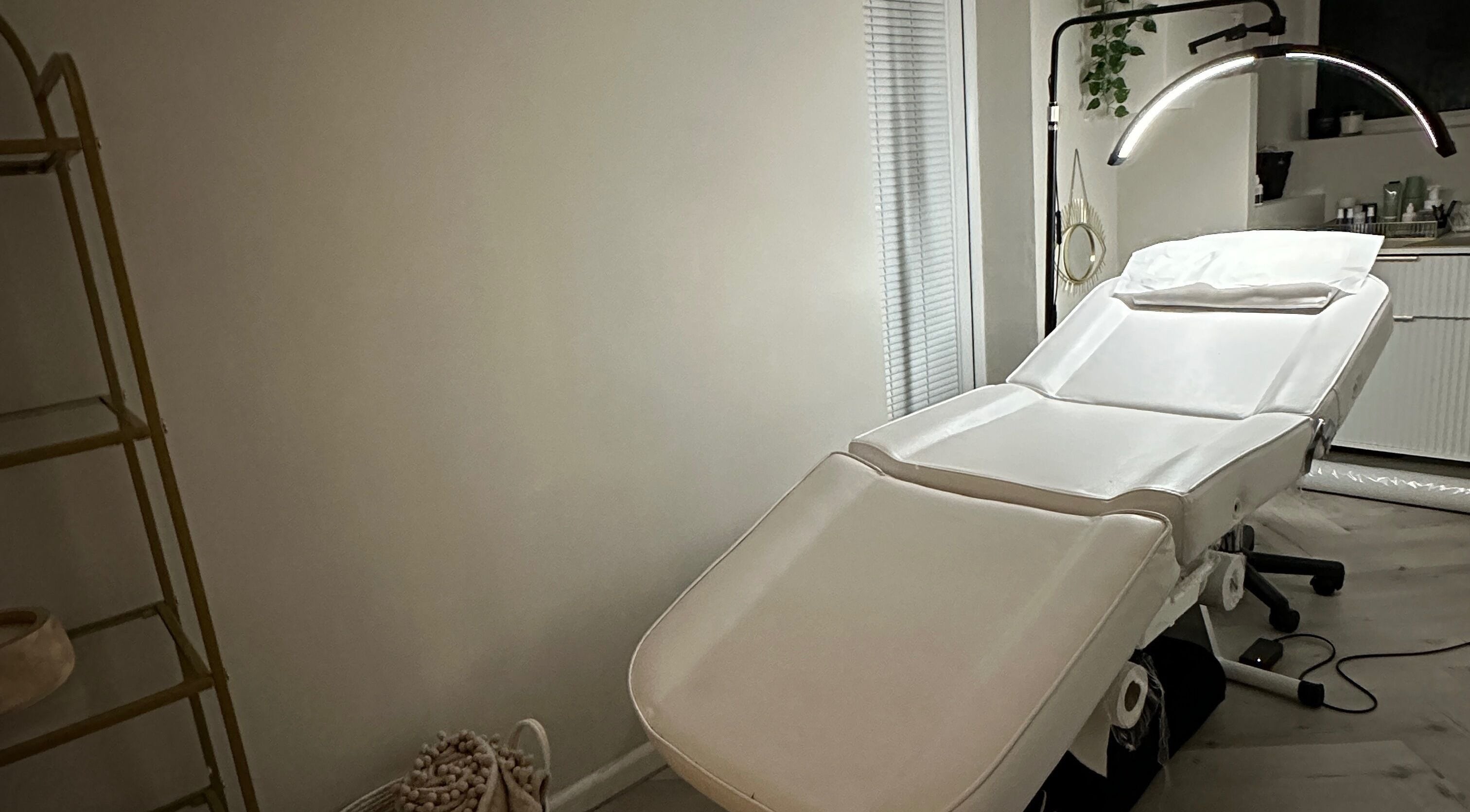 A serene treatment room at The Brow Studio in Wythenshawe, England, GB, featuring a plush white bed.