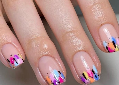 Vibrant rainbow nail art at BB, GB showing colorful designs on manicured nails.