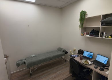 Relaxing therapy room at Kimet Adil Mobile Massage, Mareeba, Queensland, AU, with massage table and desk.