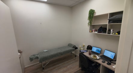 Relaxing therapy room at Kimet Adil Mobile Massage, Mareeba, Queensland, AU, with massage table and desk.