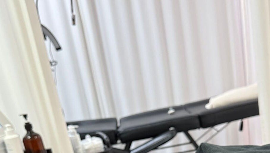 Relaxing spa treatment room at Bodyaidbham, Birmingham, England, GB with massage table and soft lighting.