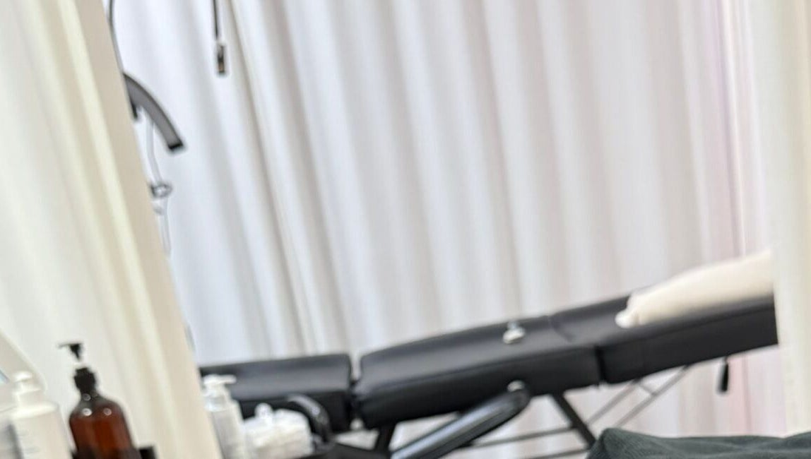 Relaxing spa treatment room at Bodyaidbham, Birmingham, England, GB with massage table and soft lighting.