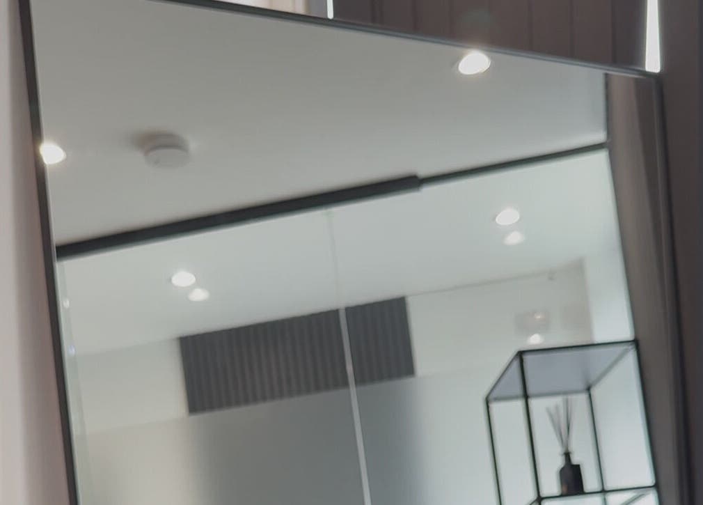 Elegant interior at Bodyaidbham in Birmingham, England featuring a large mirror and modern decor.