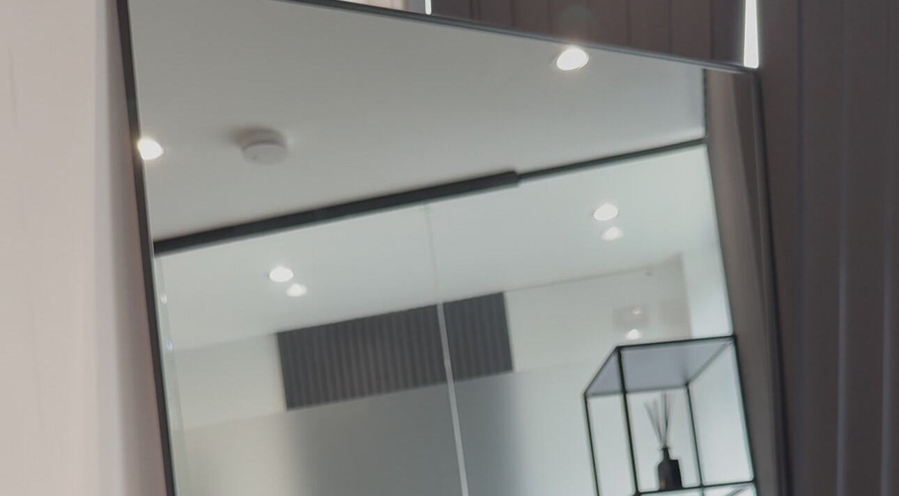 Elegant interior at Bodyaidbham in Birmingham, England featuring a large mirror and modern decor.