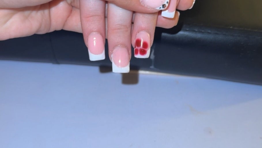 Elegant nail art featuring a flower design at Glosseditbychelsie, Clitheroe, England, GB.
