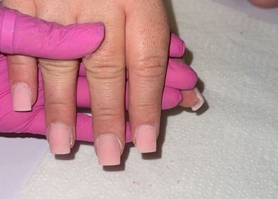 Expert nail treatment at Glosseditbychelsie, Clitheroe, England, GB. Pink gloves, elegant pink nails.
