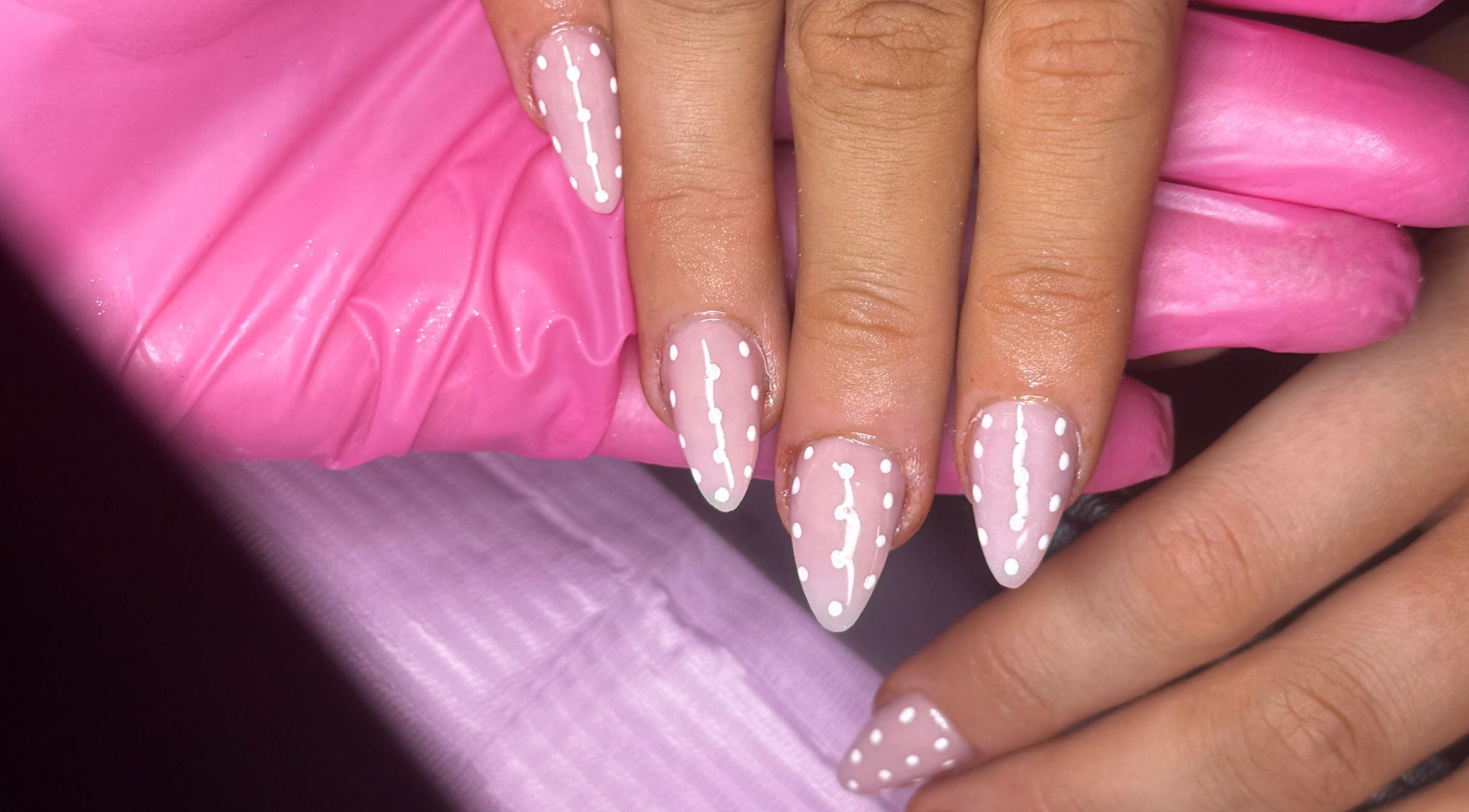 Chic pink and white polka dot nail art at Glosseditbychelsie, Clitheroe, England, GB.