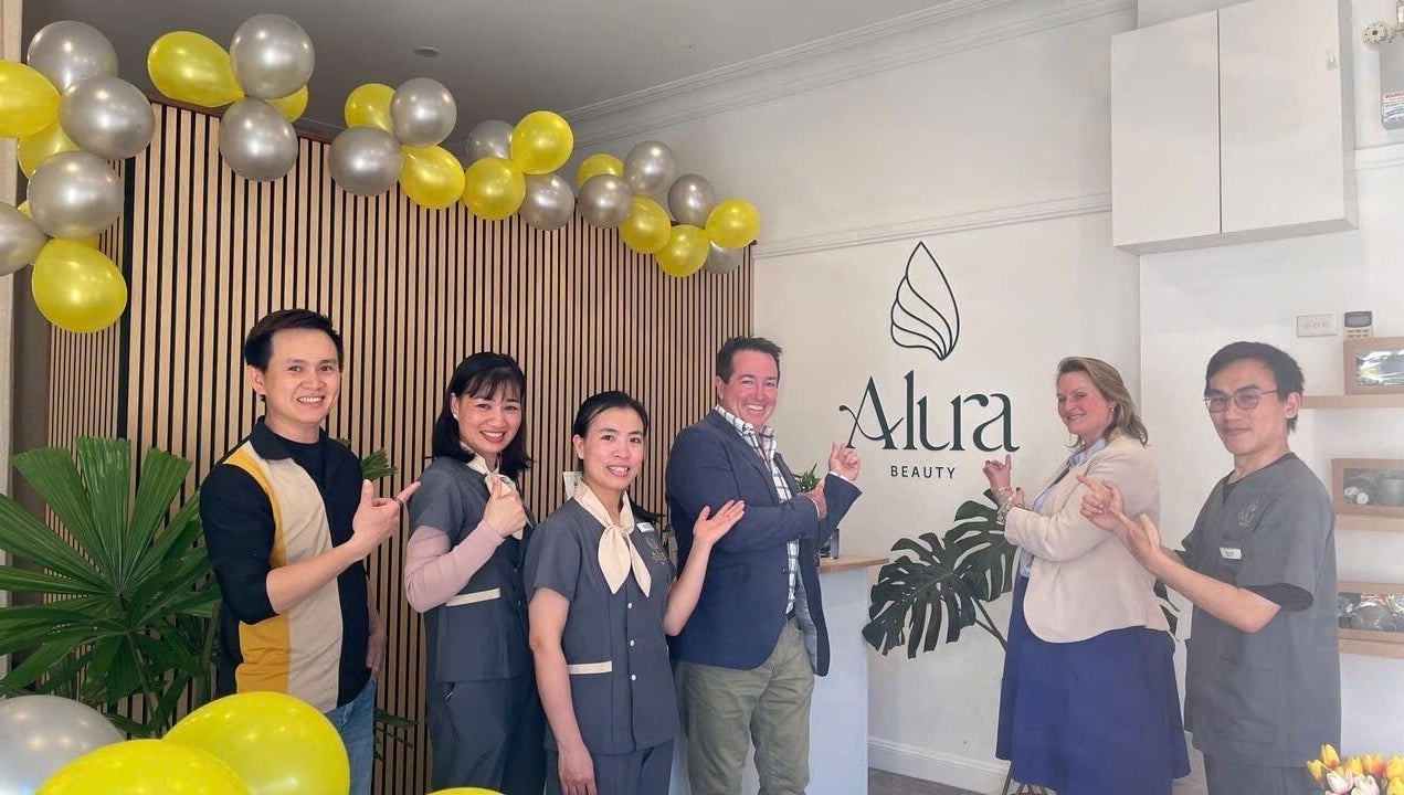 Team smiling at Alura Beauty Lithgow, located in Lithgow, New South Wales, AU with festive decor.