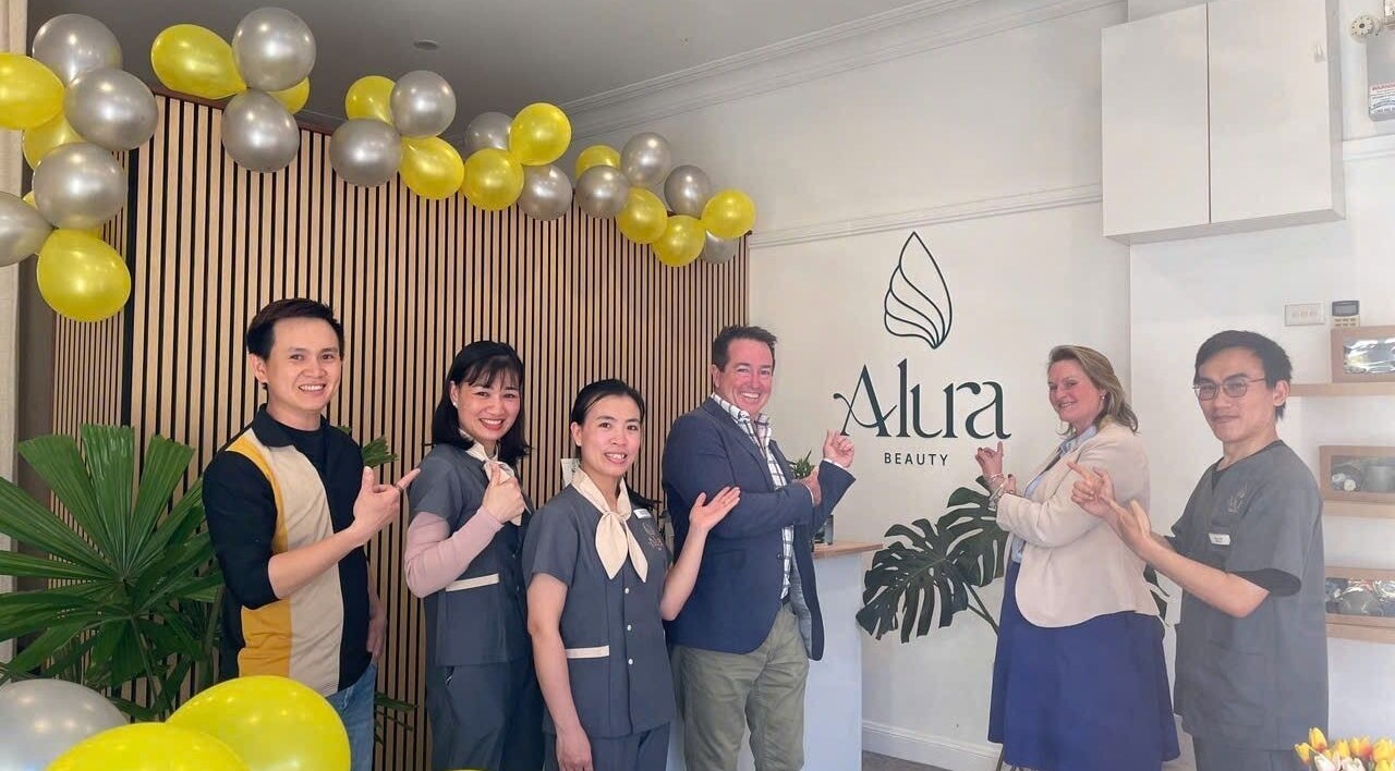 Team smiling at Alura Beauty Lithgow, located in Lithgow, New South Wales, AU with festive decor.