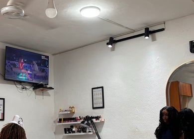 Calm interior of Looks salon in Tema, Greater Accra Region, GH, featuring TV and salon equipment.