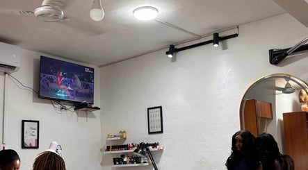 Calm interior of Looks salon in Tema, Greater Accra Region, GH, featuring TV and salon equipment.