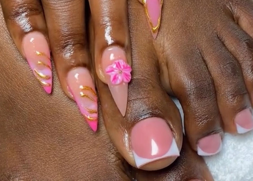 Exquisite pink and gold nail art with floral accents at Looks, Tema, Greater Accra Region, GH.