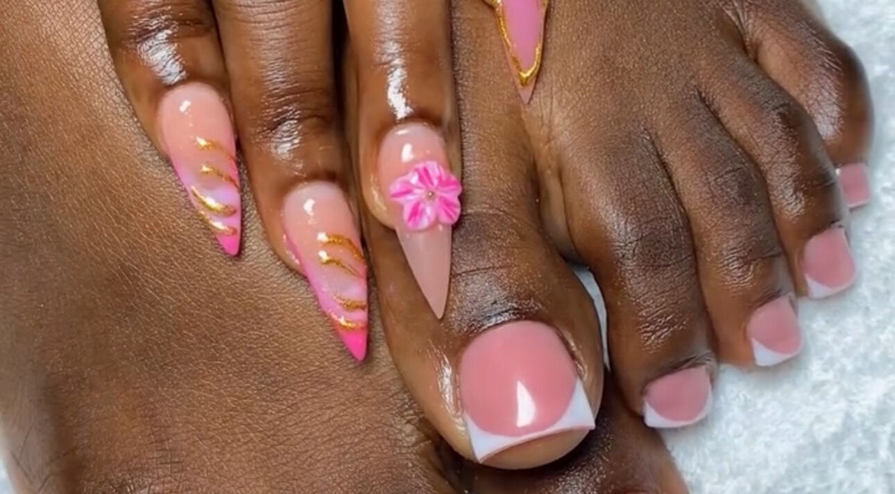 Exquisite pink and gold nail art with floral accents at Looks, Tema, Greater Accra Region, GH.