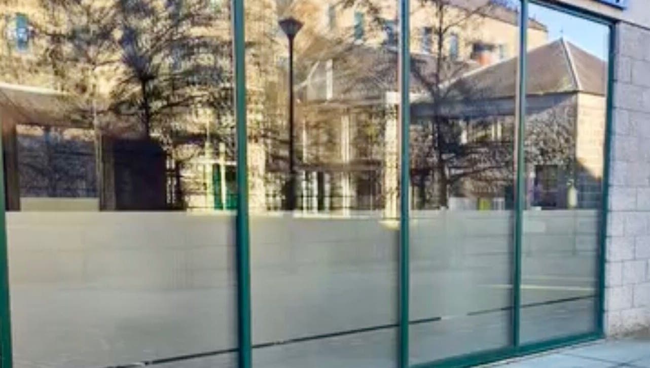 Exterior of Revive Hair And Beauty Studio in Aberdeen, Scotland, GB with glass facade reflecting surroundings.