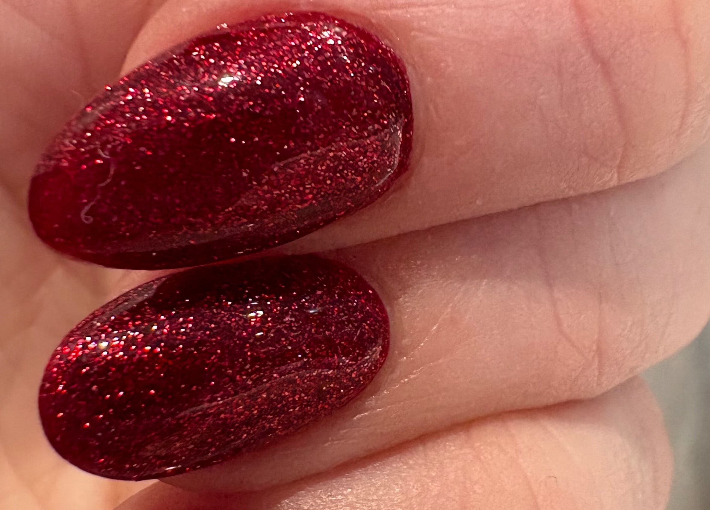 Close-up of sparkling red nails at Revive Hair And Beauty Studio, Aberdeen, Scotland, GB.