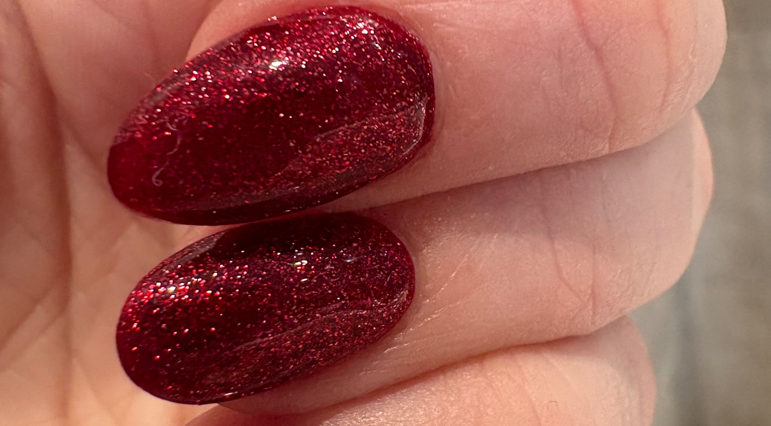 Close-up of sparkling red nails at Revive Hair And Beauty Studio, Aberdeen, Scotland, GB.