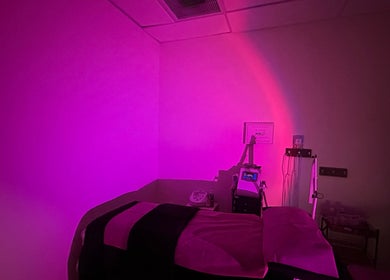 Cozy treatment room with pink lighting at Sabrina Beauty, Lincoln Park, Michigan, US.