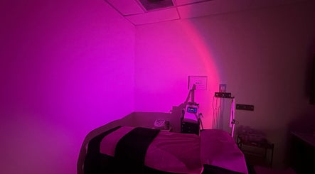 Cozy treatment room with pink lighting at Sabrina Beauty, Lincoln Park, Michigan, US.