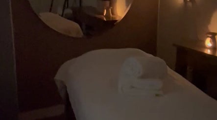 Relaxing massage room at Beautybysxph, Hamilton, Scotland, GB with gentle lighting and fresh towels.