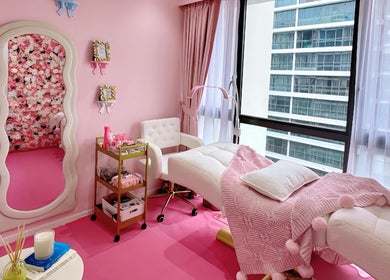 Chic spa room at Beauty Oasis with floral decor in Singapore, Singapore, SG, featuring a plush massage bed.