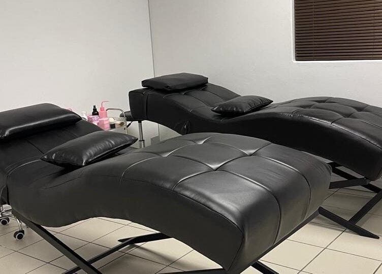 Spacious treatment room at LedyLux Beauty, Johannesburg, Gauteng, ZA with ergonomic black reclining chairs.