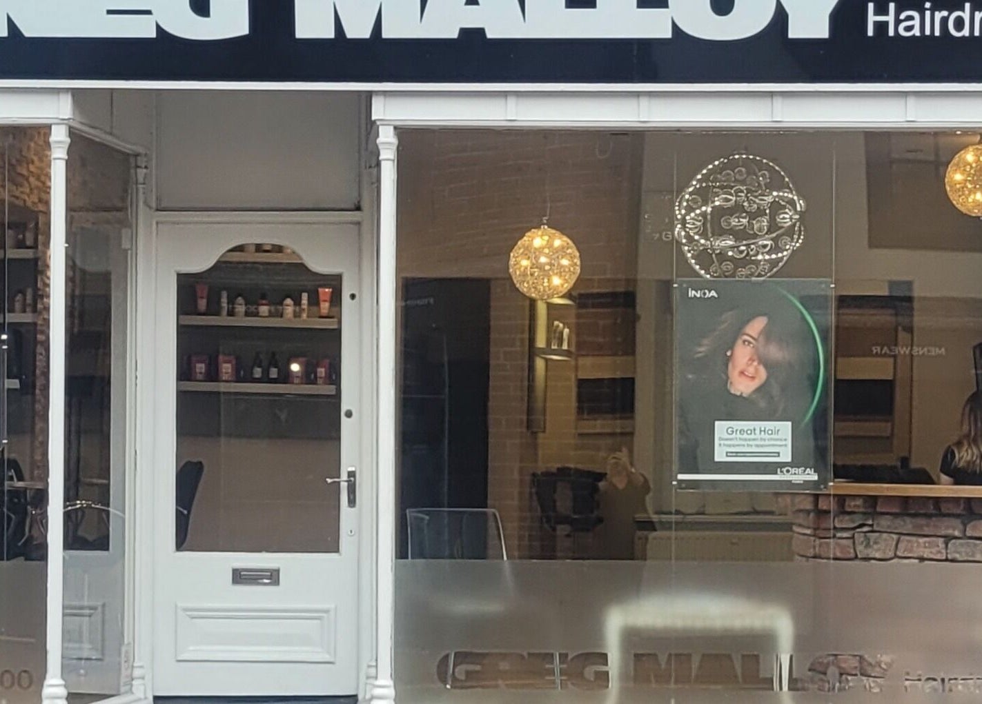 Front view of Greg Malloy Hairdressing salon in Penrith, England, GB showcasing a stylish entrance.