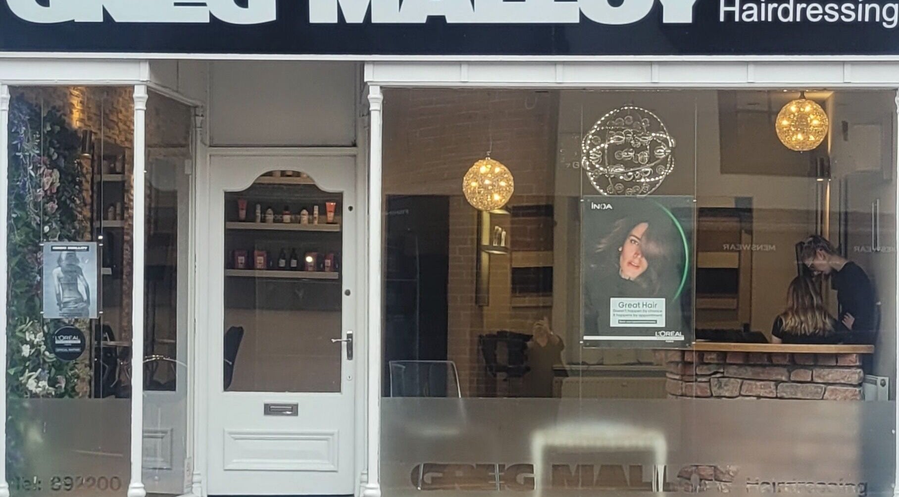 Front view of Greg Malloy Hairdressing salon in Penrith, England, GB showcasing a stylish entrance.