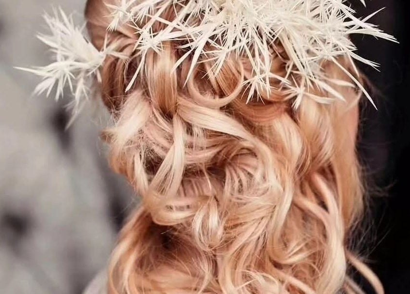 Elegant bridal updo with floral accents at Greg Malloy Hairdressing, Penrith, England, GB.