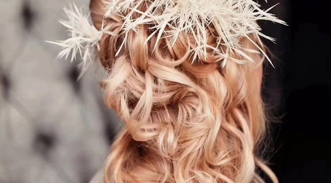 Elegant bridal updo with floral accents at Greg Malloy Hairdressing, Penrith, England, GB.