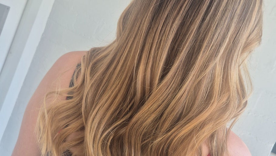 Lustrous blonde hair styled in waves at Hair by Chantelle, Worcester, England, GB.