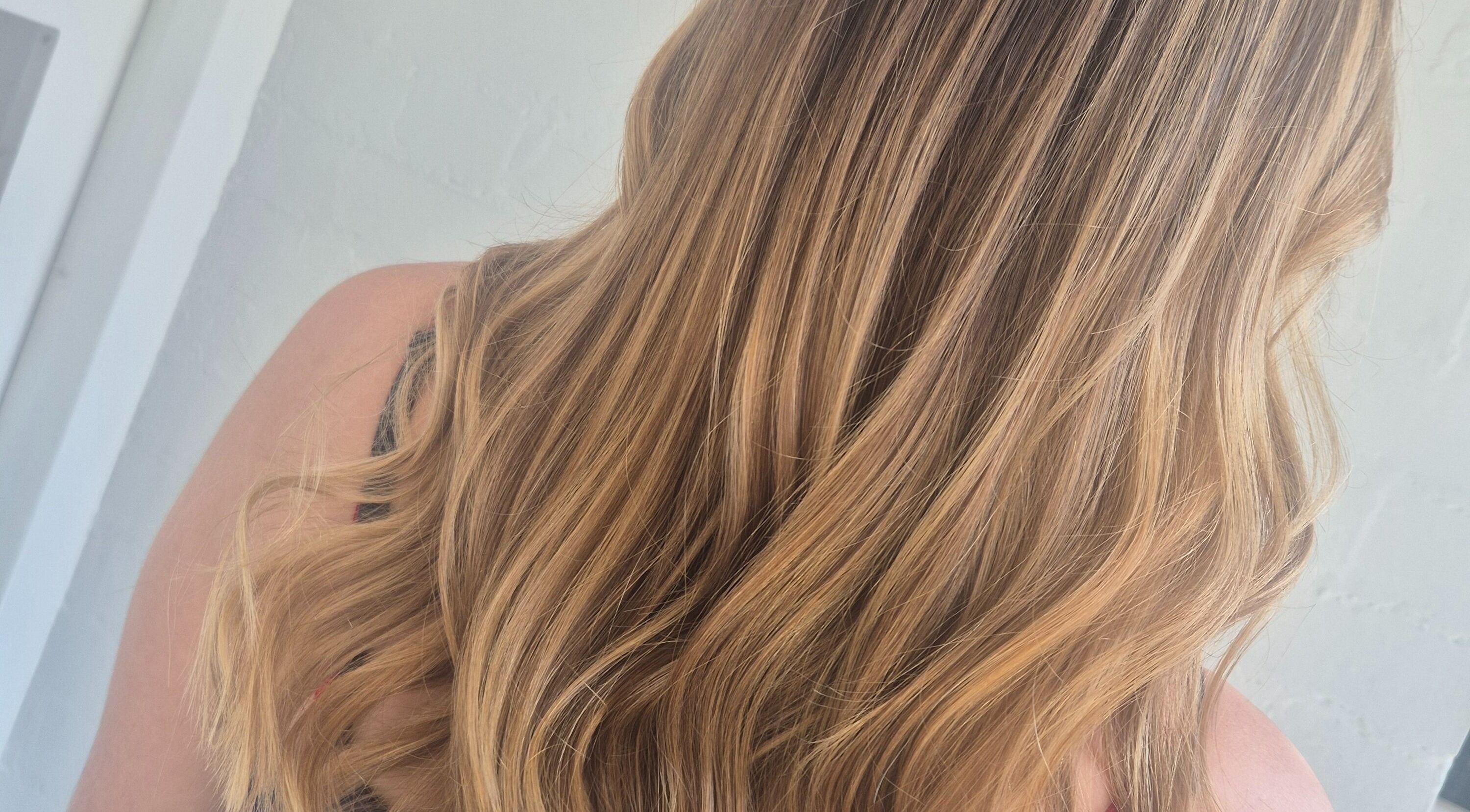Lustrous blonde hair styled in waves at Hair by Chantelle, Worcester, England, GB.