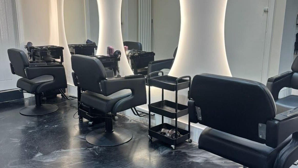 Modern salon chairs and mirrors at Jess Ram Hair, Leicester, England, GB, designed for client comfort.