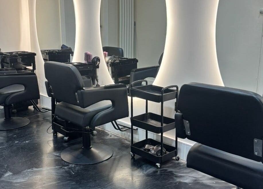 Modern salon chairs and mirrors at Jess Ram Hair, Leicester, England, GB, designed for client comfort.