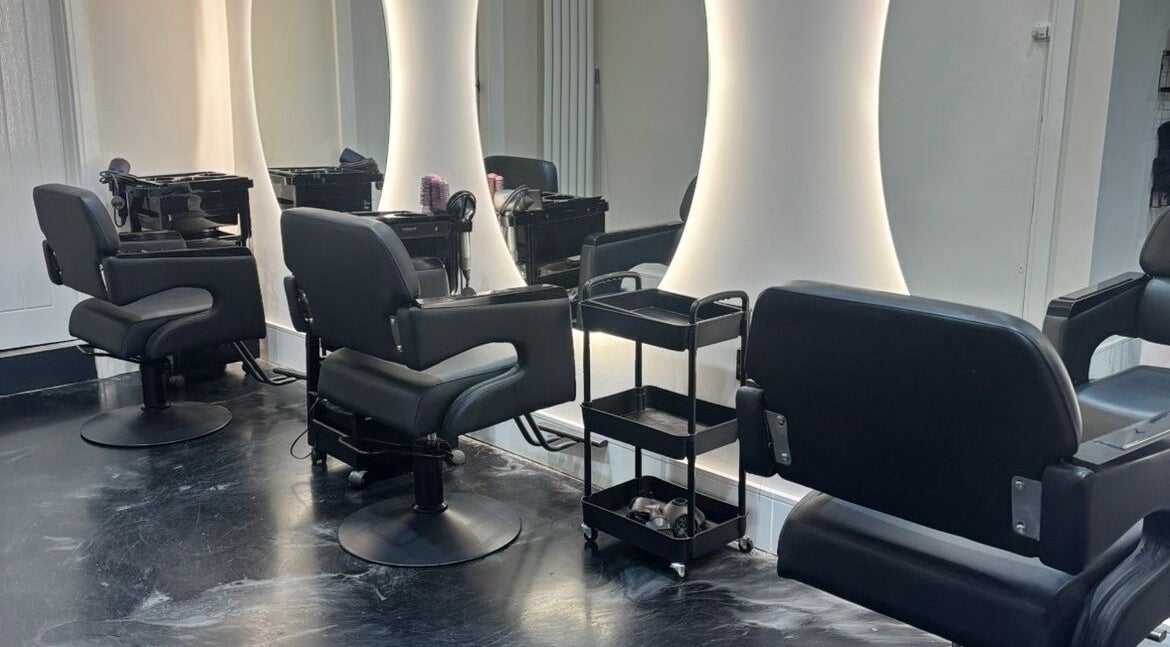 Modern salon chairs and mirrors at Jess Ram Hair, Leicester, England, GB, designed for client comfort.