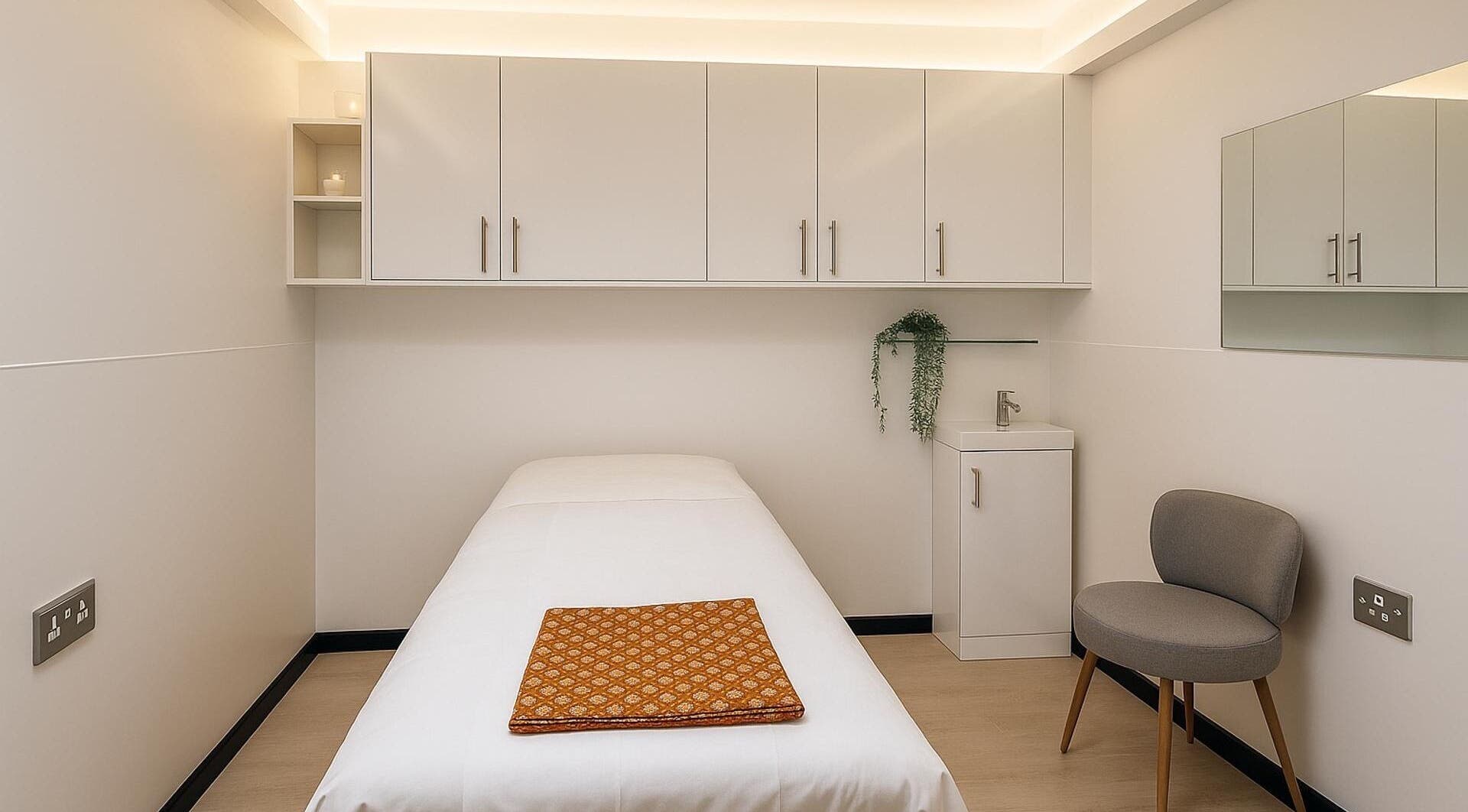 Relaxing treatment room at Catching Comfort Massage (Liverpool Street), London, England, GB, featuring a massage bed.