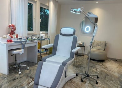 Modern treatment room at Australia Medical Centre, Dubai, AE, showcasing comfortable chair and equipment.