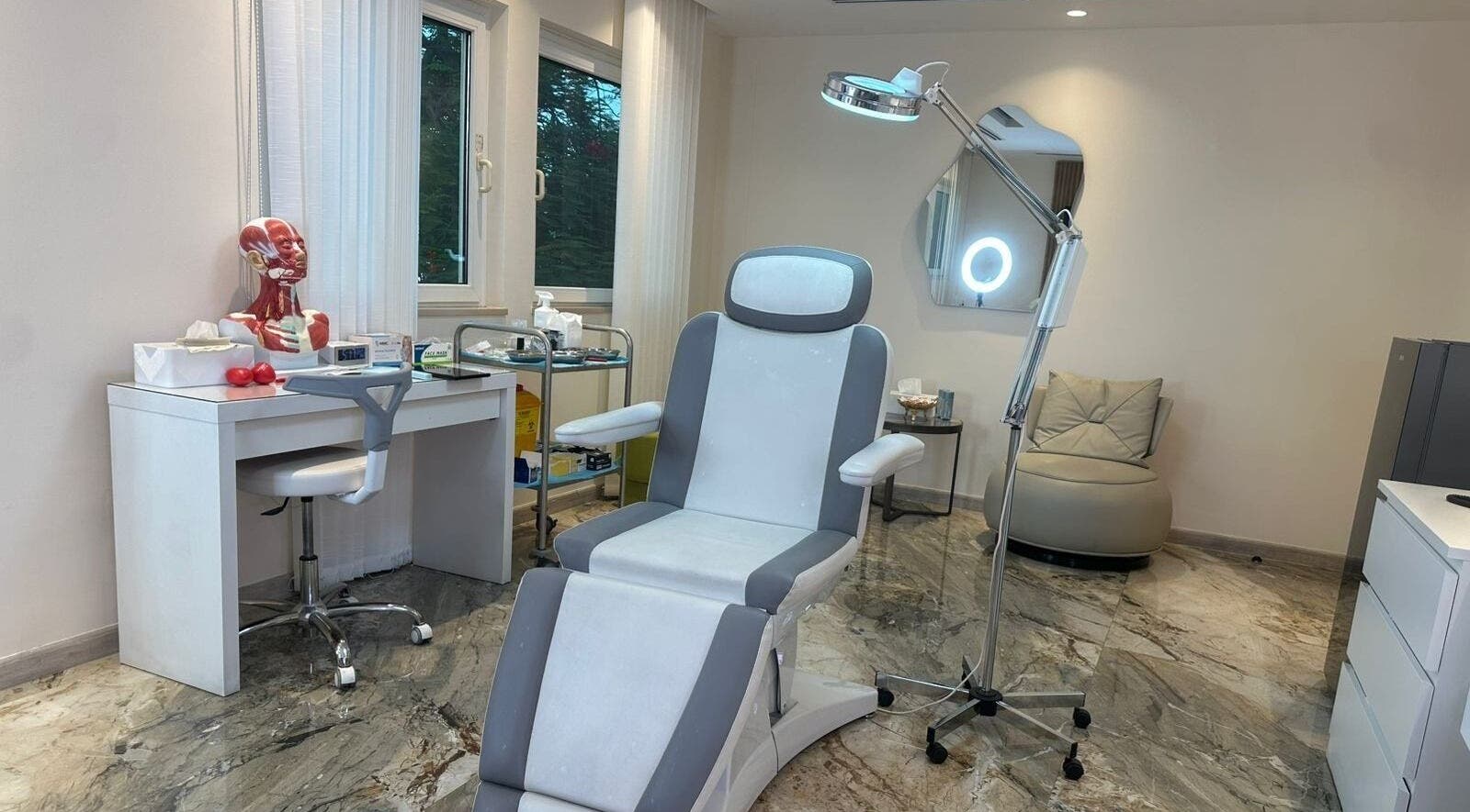 Modern treatment room at Australia Medical Centre, Dubai, AE, showcasing comfortable chair and equipment.
