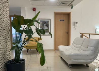Elegant waiting area at Australia Medical Centre in Dubai, AE with modern seating and plant decor.
